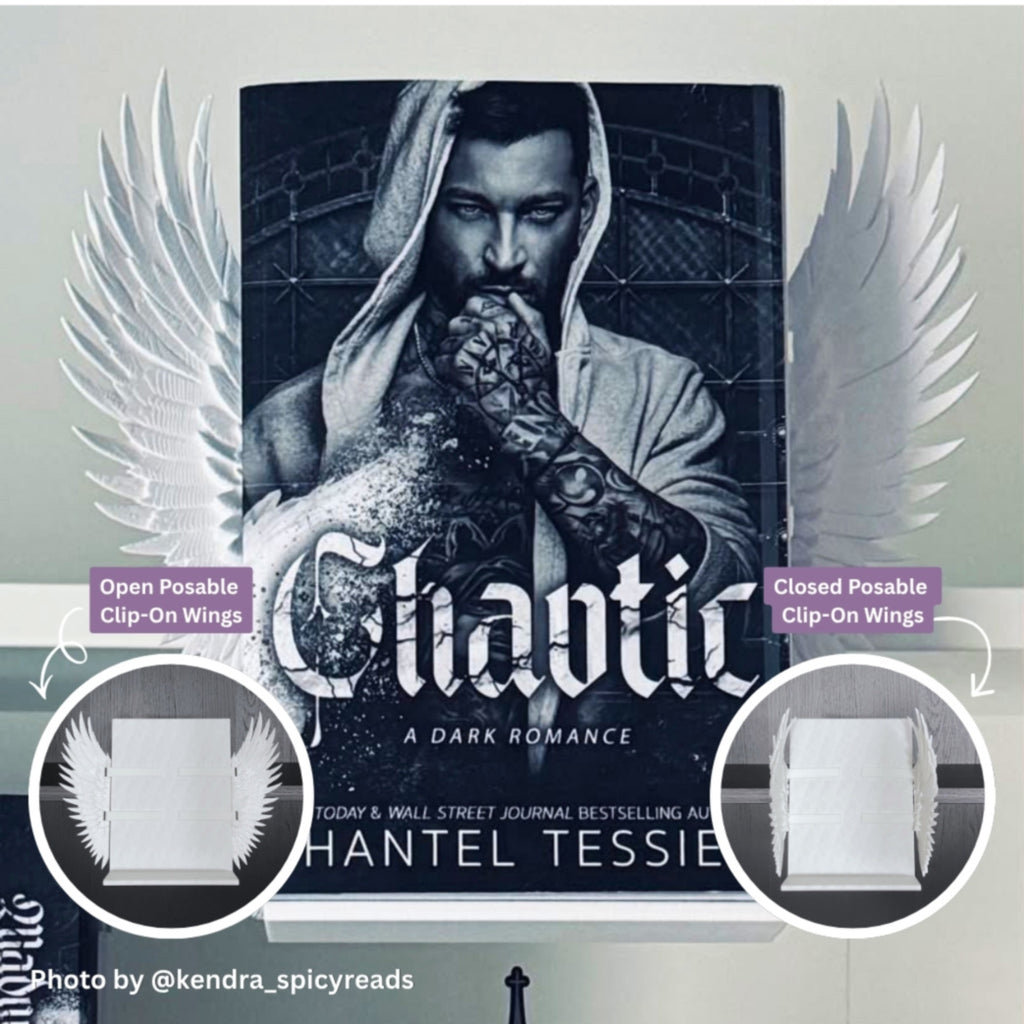 Curio Clip-On White Feathered Angel Wings attached to the Curio Candy Floating Book Display Hanger, fitting snugly on a bookshelf behind Shantel Tessie's Chaotic book cover, ideal for dark romance and spicy book displays, with open and closed posable wing options.