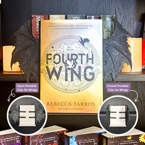 Curio Clip-On Posable Gothic Dragon Bat Wings attached to a Curio Candy Floating Book Display Hanger, showing open and closed posable positions with Rebecca Yarros's Fourth Wing on a fantasy book bookshelf.