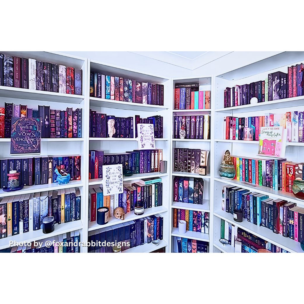 Curio Candy floating book display hangers showcasing special edition fantasy novels on white home library bookshelf wall decor.